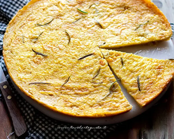 Farinata di ceci dorata e profumata al rosmarino, appena sfornata e tagliata a spicchi, pronta per essere gustata.